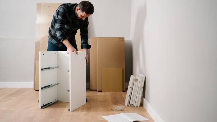 1646351181982_a-bearded-man-assembling-a-small-cabinet